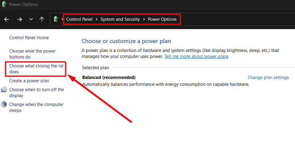  red arrow pointing to “Choose what closing the lid does” option in Control Panel
